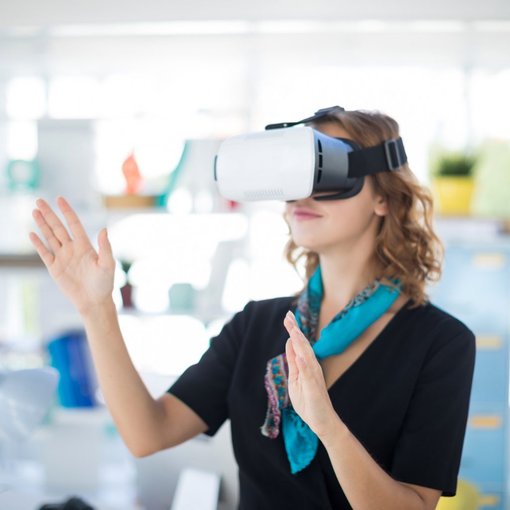 Female executive using virtual reality headset in office