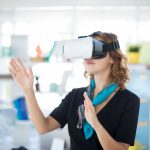 Female executive using virtual reality headset